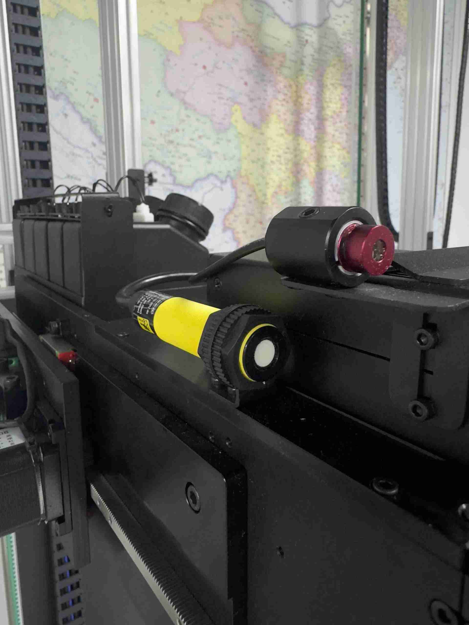 Two distance-sensing components mounted on the DXonJet wall printer printhead carriage