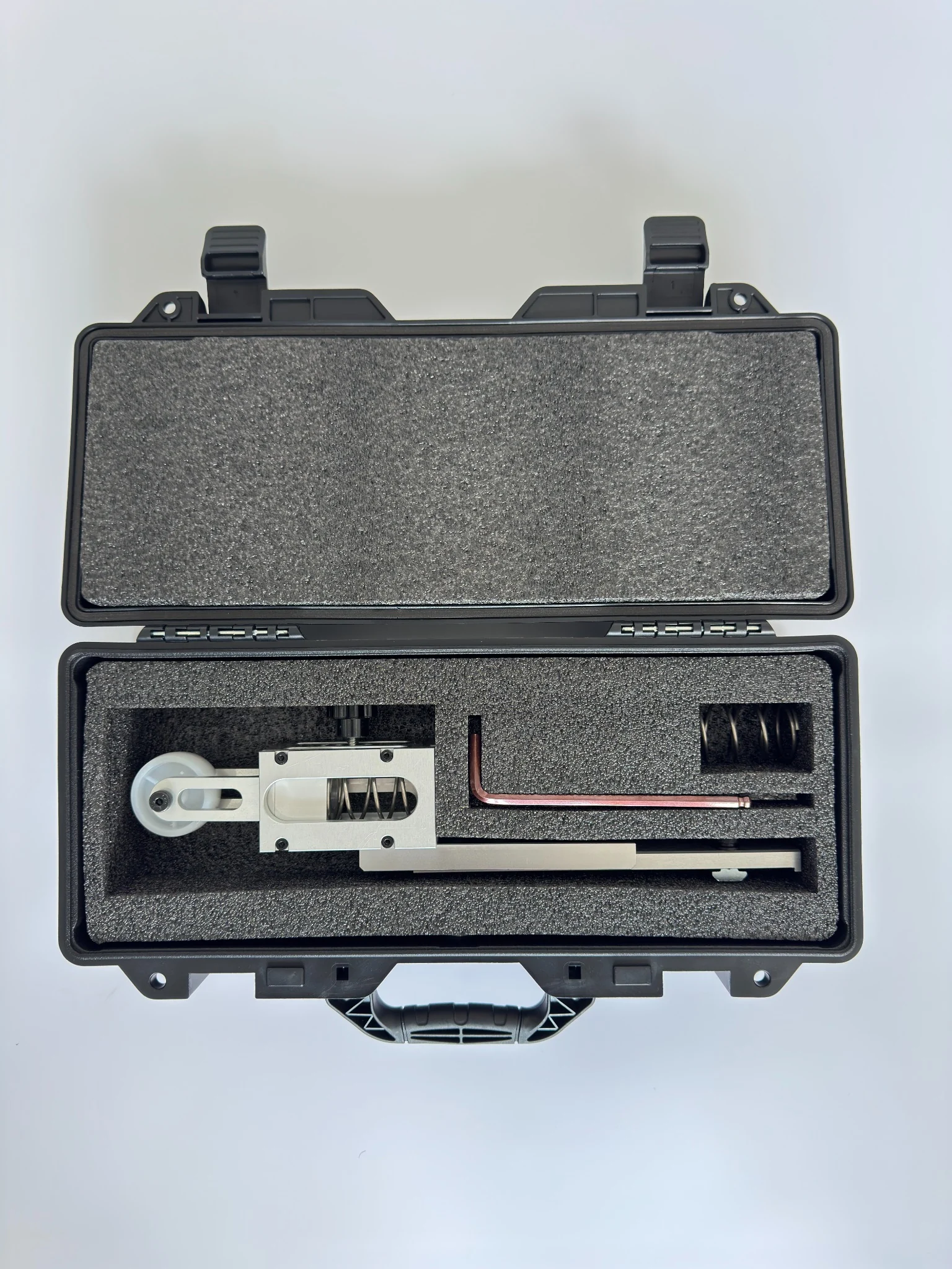 StabiArm in an open protective case with visible spring mechanism and included components