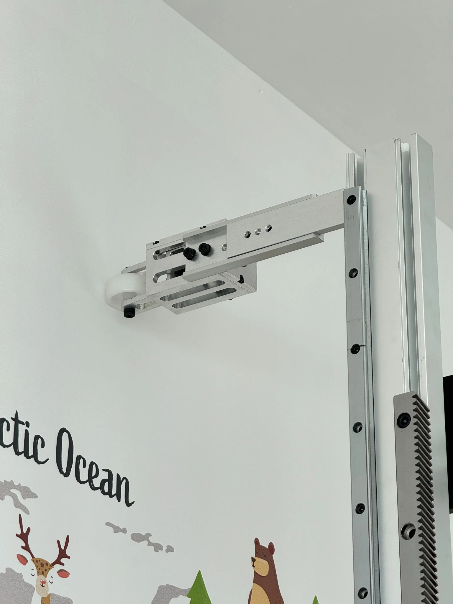 Close side view of the machined aluminum StabiArm and its adjustment holes installed on the rail